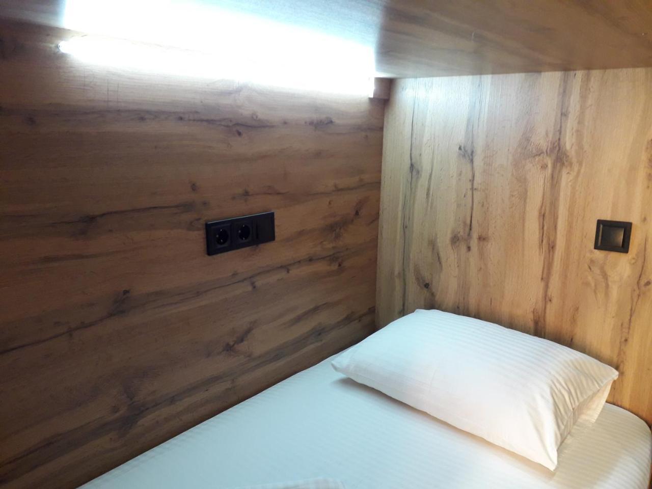 Full House Capsule Hostel Ривне Екстериор снимка A single bed in a capsule hotel