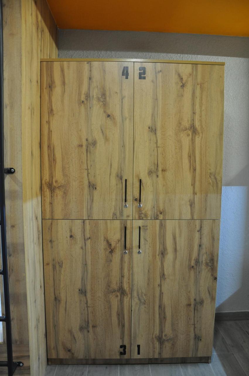 Full House Capsule Hostel Ривне Екстериор снимка A wooden armoire